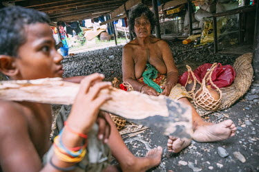 Elsie Peaka, 58, and her grandson Brandy, 11, sell 'kaha', traditional water containers made of coconuts. Elsie says: 'I moved to Honiara in 2004 because all my children left Ontong Java. There is nob...
