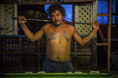 Thomas 'Master' Mahu, 45, plays pool in a pub in Lord Howe Settlement. He says: 'I came to Honiara in 1998 from my home island of Pelau on Ontong Java to look for a job. Now I work as a builder in a c...