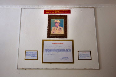 A portrait of former junta senior general Than Shwe hangs on the wall above a plaque bearing an excerpt of his speech from March 1996 regarding drug eradication in the Museum of Narcotic Drugs in Mong...