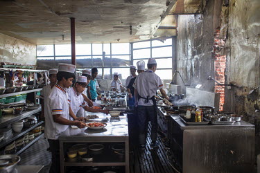 Chefs prepare dishes in a kitchen at a 'wildlife' restaurant in Mong La. Different kinds of live animals ranging from snakes and pangolins to turtles and others are kept in cages in front of the wildl...