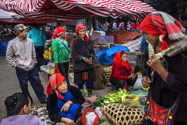 Ethnic Shan women sell vegetables in the market in Mong La.  The town of Mong La on the Burma - China border in western Burma (Myanmar) is technically in Burma but relies on most infrastructure - elec...