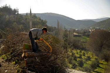 A young boy cutting wood. Guvecci, situated on the Turkish border with Syria, was once a central hub for smuggling of munitions and supplies to the Free Syrian Army. However, smuggling activities have...