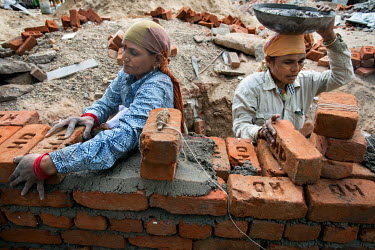 Members of the Self Employed Women's Association (SEWA) working as bricklayers on a building site. SEWA began in Gujarat in 1972 when a group of poor, illiterate women working as casual labourers in A...
