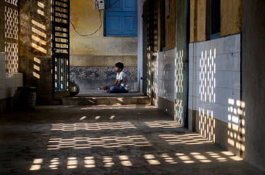 A boy eating breakfast at the Sanatan Seva Mandal school and orphanage in Dwarka which provides an education for 435 students whose parents can't afford government schools. Around half the students, m...