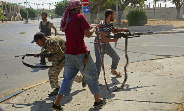 Rebels firing machine guns in the Abu Salim neighbourhood of Tripoli with loyalist elements of the Gaddafi regime returning fire.