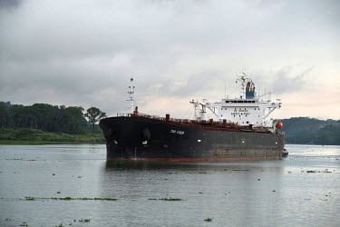 A ship traverses the artificial lake Gatun which links the Panama canal and supplies water to its locks.