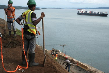 Men working on the Panama Canal Expansion, which is due to open on 26 June 2016, standing on the shore of Lake Gatun. When complete the project will allow ships specified as New Panimax, 320.04m (1,05...