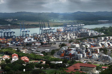 Derricks and containers in Panama City port on the Pacific coast.Construction work for the Panama Canal Expansion will allow ships specified as New Panimax, 320.04m (1,050ft) (l) x 33.54m (110ft) (w)...