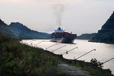 A container ship crossing the most difficult part of the Panama Canal, the Culebra Cut. During the Panama Canal Expansion, which is due to open on 26 June 2016, this channel has been deepened. When co...