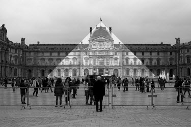 French street artist JR fitted a giant photograph of the entrance to the Louvre Place over I.M Pei's glass pyramid that stands in front of the building. When viewed from directly in front of the pyram...