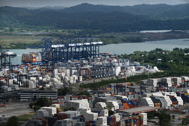 Derricks and containers in Panama City port on the Pacific coast. Construction work for the Panama Canal Expansion will allow ships specified as New Panimax, 320.04m (1,050ft) (l) x 33.54m (110ft) (w)...