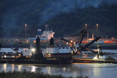 A dredger creates a new channel during construction work for the Panama Canal Expansion. When complete, 26 June 2016, ships specified as New Panimax, 320.04m (1,050ft) (l) x 33.54m (110ft) (w) x 12.56...