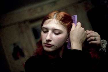 Masha combing her hair. Masha has been homeless, living in empty basements with other teenagers and sniffing glue. She now lives between her abusive boyfriend's house and a friend's mother's apartment...
