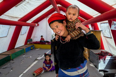 A Nepalese woman and her baby inside a tent at the Spinal Injury Rehabilitation Centre in Sanga.