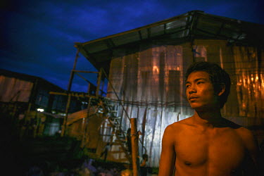 A Burmese migrant in front of the Burmese quarter in Chaing Mai.