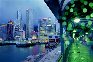 The dramatic Hong Kong Island skyline with the Star Ferry terminal during typhoon season.