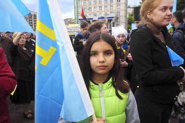 A girl holds the national flag of the Crimean Tatar people during a commemoration of their deportation to Central Asia by the Soviet state on 18 May 1944. Today, as Russia tightens its grip on occupie...