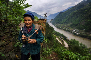 A Lisu woman walks in the hillside above the Nujiang River.