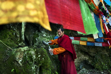 Local Nu, Lisu and Tibetan people celebrate the Fairy Festival and arrival of spring by collecting water dropping from stalactites in a sacred cave and making an offering at a Tibetan Buddhist altar.