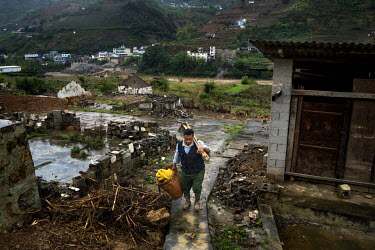Chen Dehua, 67, an ethnic Bai farmer, leaves the shack he built on his old home that he was forced to move from ahead of the planned construction of a dam project that is now on hold, on the bank of t...