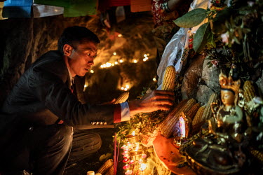 Local Nu, Lisu and Tibetan people celebrate the Fairy Festival and arrival of spring by leaving offerings of maize at a Tibetan Buddhist altar in a sacred cave.