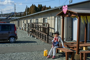 Inaride Yuko sits outside the home in the Koike 1 camp where she has been living since 2011. Her home, one kilometre from the sea, was destroyed during the tsunami that followed the 11 March 2011 magn...