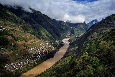 Mian Gu village, a government housing project to encourage people living in the mountains to live near the riverside and prevent deforestation, on the west bank of the Nujiang River.