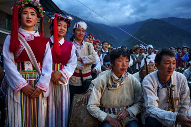 Men & women from nearby villages, dressed in traditional Nu and Tibetan costumes, wait to go on stage at the annual Fairy Festival where local Nu, Tibetan and Lisu minorities dance and perform.
