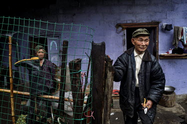 Pu Yi Na, 60, and his wife Du You Lan, 60, stand outside their home on the bank of Pula River, a tributary of the Nujiang River 2km from its confluence.