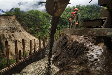 Migrant construction workers from Chu Xiong in central Yunnan building a bridge as part of the extension of the road along the Nujiang River to Tibet, a major government project hoping to bring touris...
