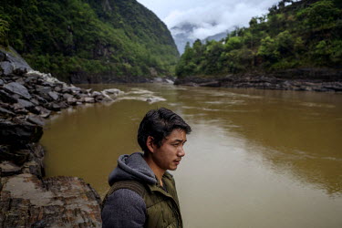 Deng Si Hua, 24, fishing in the Nujiang River. He and his brother have been fishing in the river since they were 10 years old but say 'there aren't many fish these days'.