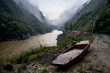 Boats used for surveying the proposed Maji Dam Site lie abandoned on the side of the road that runs along the Nujiang River.