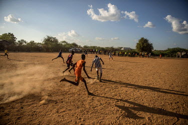 Refugee children play football in Dadaab refugee camp.
