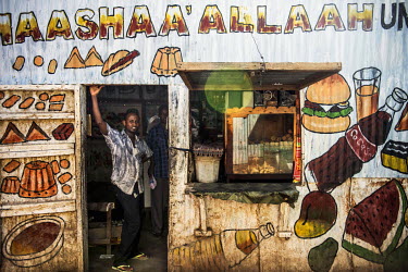 A shopkeeper stands in the doorway of his grocery store in Dadaab refugee camp.