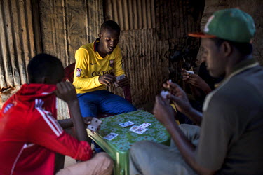Mahmoud Liban Abdullah, 21, plays cards with friends in Dadaab Refugee camp.