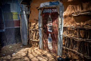A doorway, with a hand painted Coca-Cola advertisement, in Dadaab refugee camp.