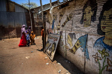 Refugees walk past a beauty salon in Dadaab refugee camp.