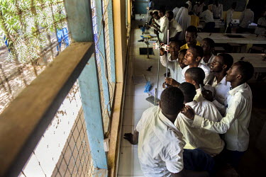 Aden Abdi Ali, 21, takes part in a practical science experiment at the Ifo secondary School in Dadaab refugee camp.