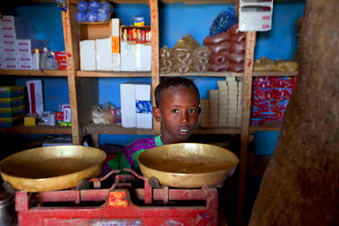 A boy stands behind scales on the counter of a small shop.  A devastating drought is causing the worst food crisis to hit Ethiopia in 30 years, putting millions of people at risk of hunger and disease...