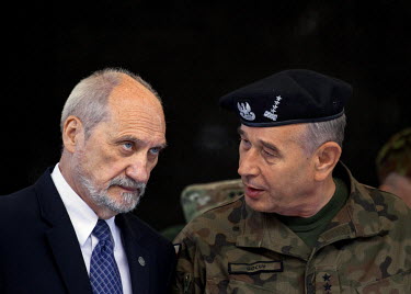 Polish defence minister Antoni Maciarewicz (R) and general Mieczyslaw Gocul talk during a ceremony at the National Defence Academy for the official opening of the Nato multinational exercise 'Anaconda...