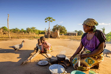 Elsa Amorinho, 30, a single mother living in the Mussanga community, prepares breakfast for herself and her children. It is the only meal they will eat that day. Although her life has been made easier...