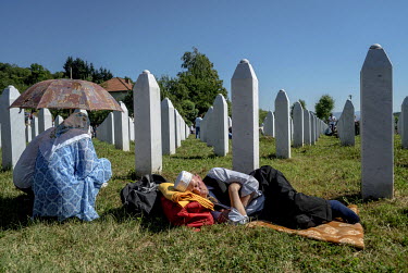 A man sleeps amongst the graves of victims of the massacre of Srebrenica. A ceremony was held today to mark the 21st anniversary of the massacre. On this occasion, 127 victims of the massacre were bur...
