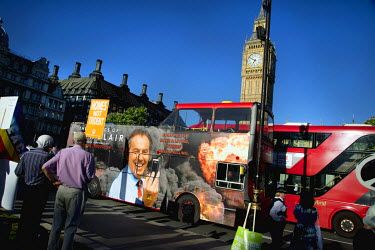 A photo montage on a bus by Peter Kennard and Cat Picton Phillipps of Tony Blair taking a selfie whilst Iraq burns is seen near a protest against the renewal of the Trident nuclear missile programme a...