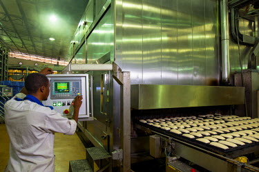 A man operates a machine at Pain Victoire, an industrial bakery with the capacity to produce six million baguettes per day. The Lebanese owned facility supplies various outlets in and around the capit...