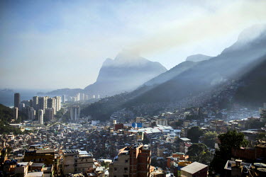 High rise condominiums in the wealthy neighbourhood of Sao Conrado, left, and the sweeping landscape of Rocinha, the largest single favela in Rio de Janeiro.