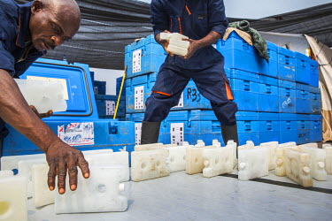 Medecins Sans Frontieres (MSF) staff move 17000 icepacks into coolers containing yellow fever vaccines, which must be kept at between 2 - 8 degrees Celcius, in preparation for a massive immunisation c...