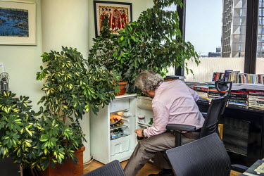 Can Dundar, the editor-in-chief of the national newspaper 'Cumhuriyet' (Republic), checking the fridge in his office. Dundar was charged with treason and espionage after his newspaper ran a story expo...