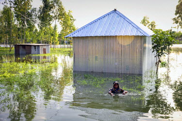 Bela Begum searches for her lost household items in flood water aroung her home.   At least 820,000 people have been affected by floods and the situation is deteriorating on a daily basis as dangerous...