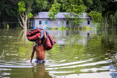 A man carries a mattress from his flooded property.  At least 820,000 people have been affected by floods and the situation is deteriorating on a daily basis as dangerously high river levels have forc...