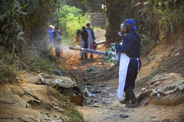 A member of Medecins Sans Frontieres (MSF) staff fumigates with an insecticide, to kill mosquitos, in an area where there have been confirmed cases of yellow fever.
